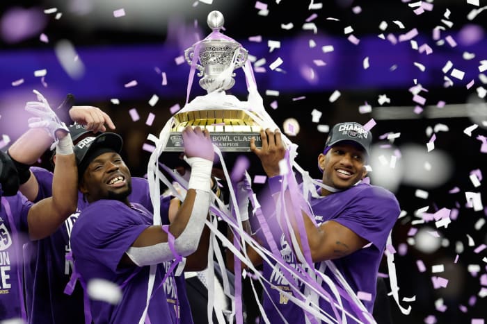 Washington Huskies quarterback Michael Penix Jr. celebrates with the Sugar Bowl Trophy